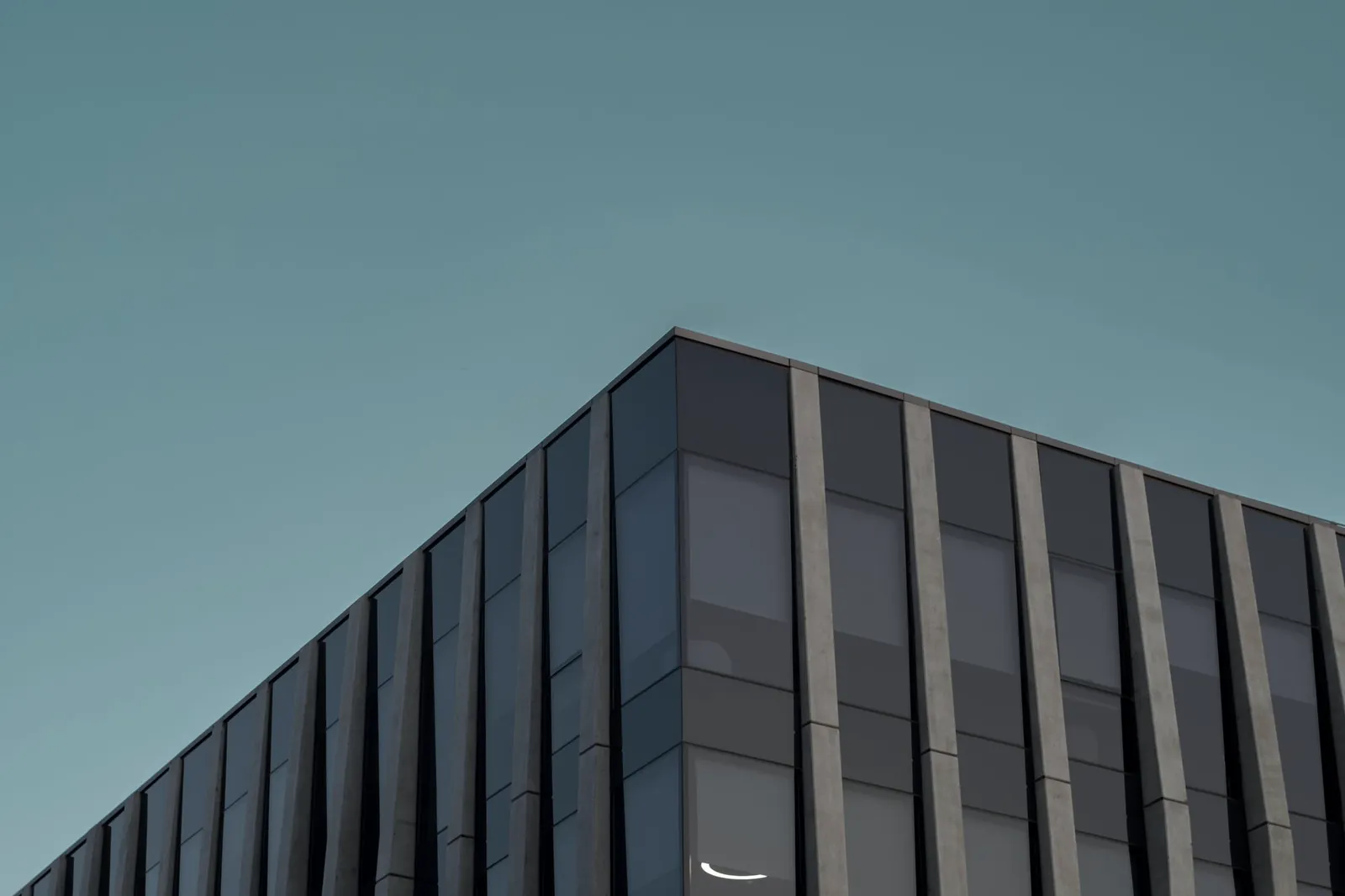 Angular glass office building against a clear sky