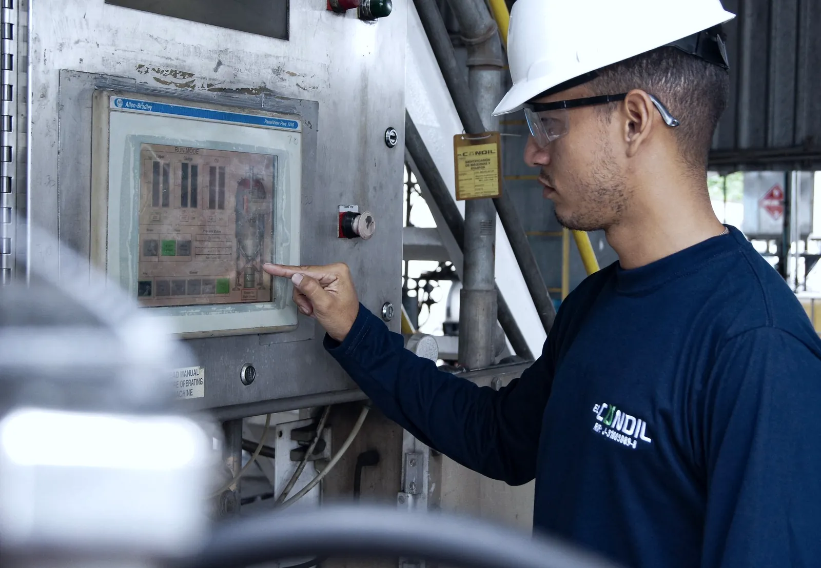 Engineer operating a control panel in an industrial facility